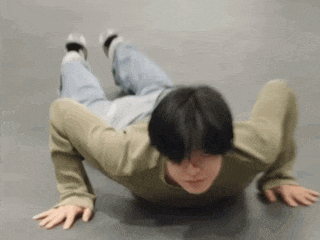 a man is doing push ups on the floor with his hands on the floor .