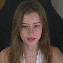 a close up of a woman 's face with her mouth wide open