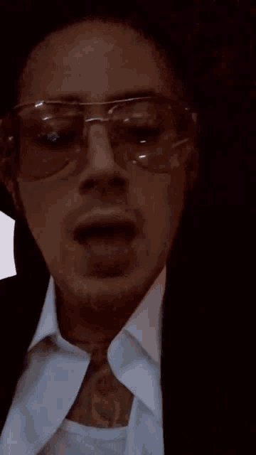a man wearing sunglasses and a white shirt says i don 't give a fuck