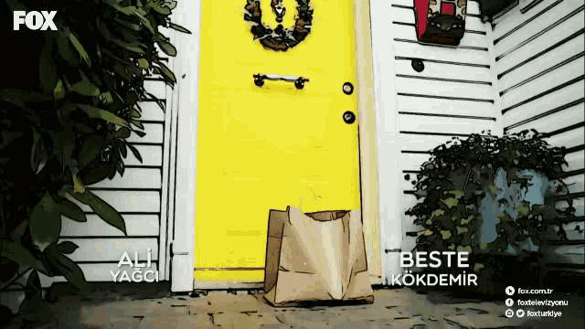a yellow door with a brown bag in front of it and a fox logo