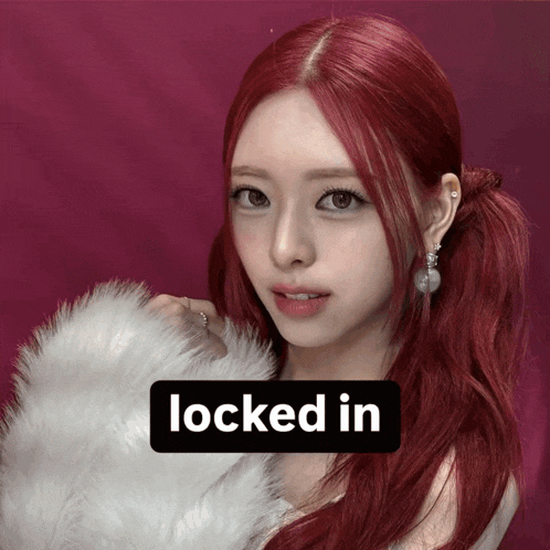 a woman with red hair has a sign that says locked in