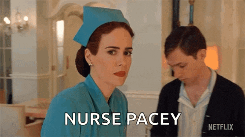 a woman in a blue nurse 's uniform is standing next to a man and says nurse pacey