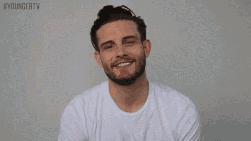 a man with a beard is laughing with the hashtag youngertv