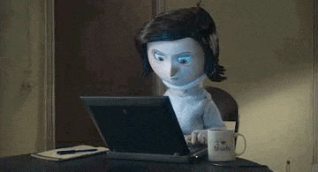 a cartoon doll is typing on a laptop computer .