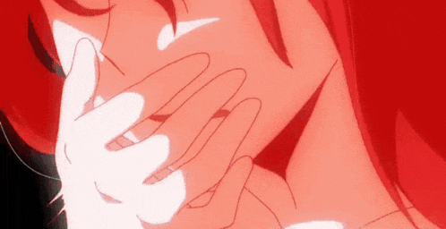 a close up of a person 's face with red hair and a white hand covering her mouth .