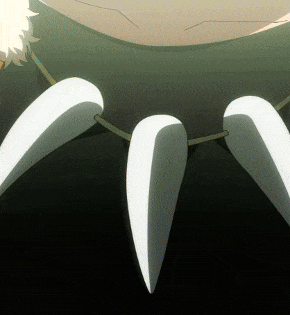 a close up of a person 's teeth with a necklace around their neck