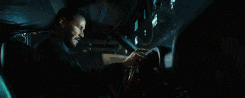 a car is driving down a wet street at night