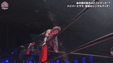 a woman in a pink mask is laying on the ground in a wrestling ring with #tjpw written on the bottom