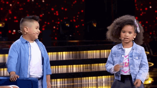 a boy and a girl are standing next to each other