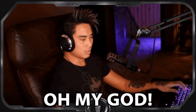 a man wearing headphones is sitting in front of a microphone with the words oh my god behind him