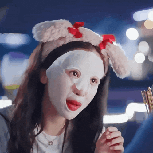 a woman wearing a mask and a headband with bunny ears