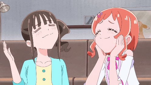 two anime girls are sitting next to each other and one has her eyes closed