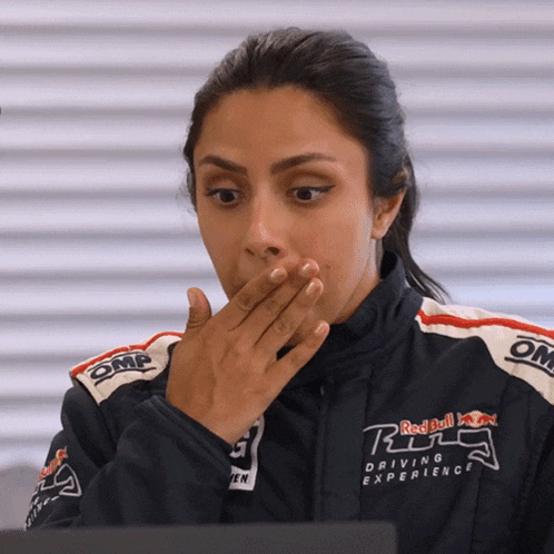 a woman wearing a jacket that says red bull driving experience