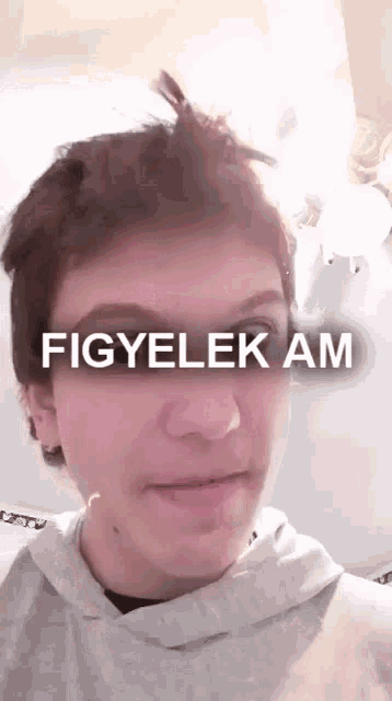 a close up of a person 's face with the words figyelek am written on it .