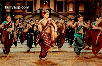 a group of women are dancing together on a dance floor .