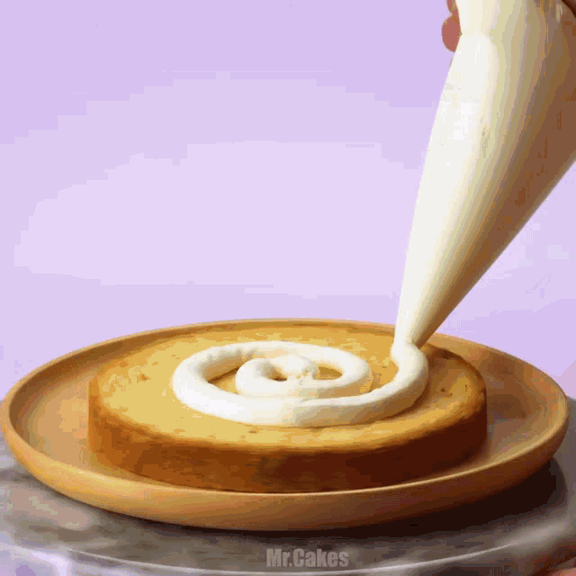 a person is frosting a cake with a bag that says mr.cakes on the bottom