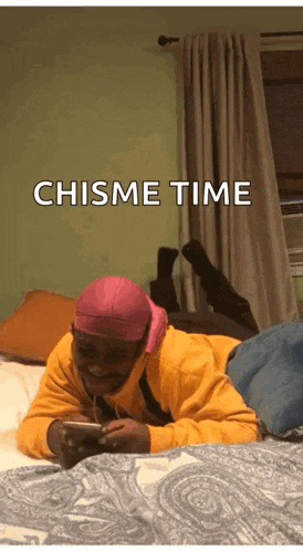 a man is laying on a bed looking at his phone with the words chisme time below him