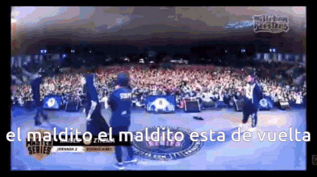 a group of people standing on a stage with the words el maldito el maldito esta de vuelto written on the bottom
