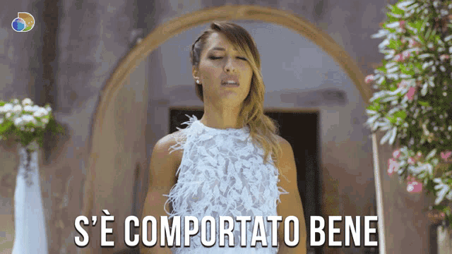 a woman in a white dress says s ' e comportato bene in a foreign language