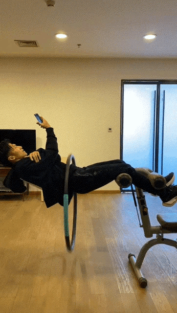a man is laying on a bench with a hula hoop around his waist
