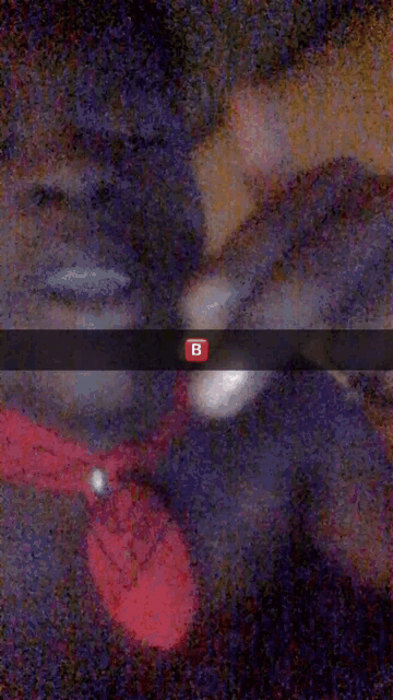 a blurry picture of a person 's face with the letter b on it