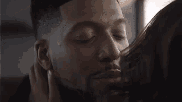 a man and woman are kissing in a car
