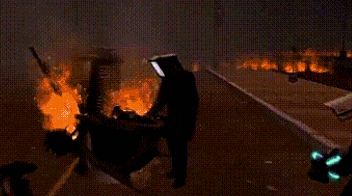 a car is on fire in the middle of a highway at night .