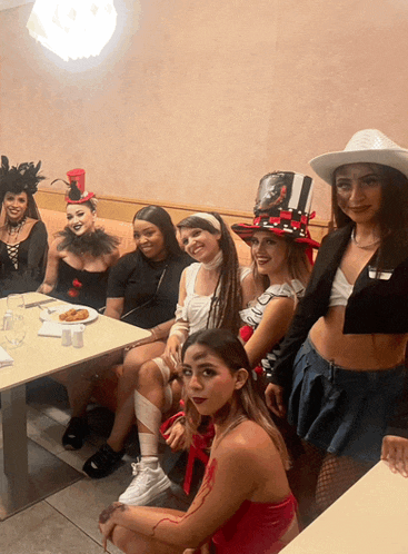 a group of women are sitting at a table with a plate of food on it