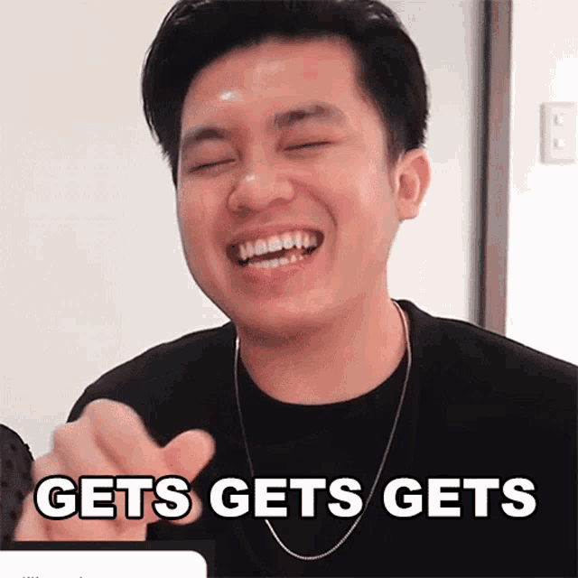 a man is smiling and pointing with the words gets gets gets on the bottom