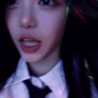 a close up of a woman wearing a tie and ear buds .