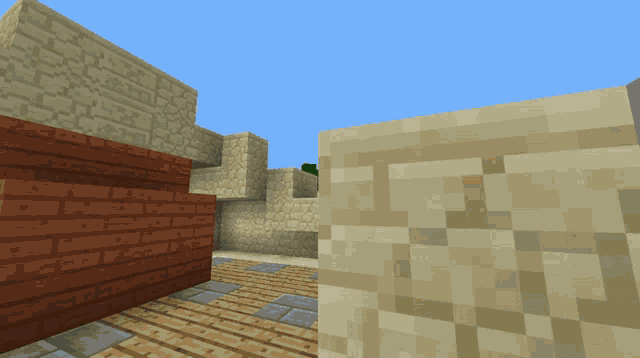 a brick wall is next to a sand wall in a minecraft world