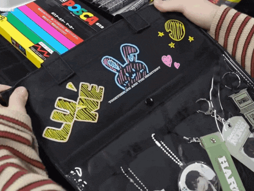 a person is holding a black bag that says " love " on it