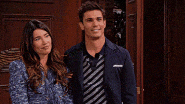 a man and a woman standing in front of a door