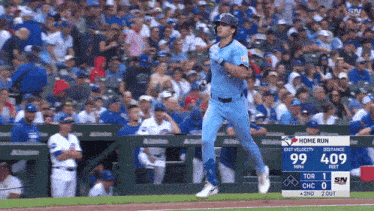 a baseball player in a blue jays uniform is running on the field