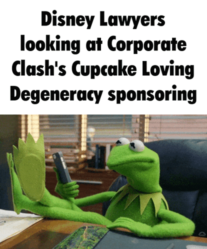 kermit the frog sits at a desk with his feet up looking at a cell phone