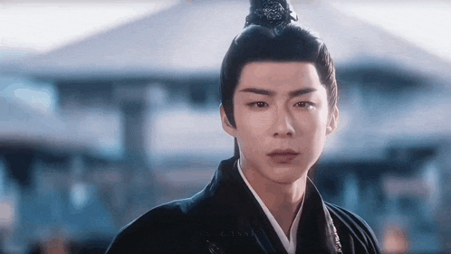 a man in a traditional costume with a bun on his head .