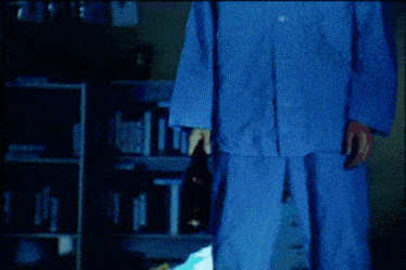 a man in pajamas is standing in a room