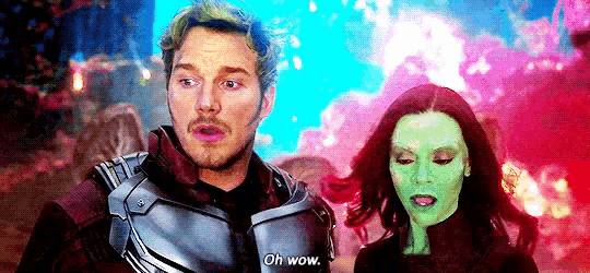 a man and a woman are standing next to each other and the woman is wearing a green face .