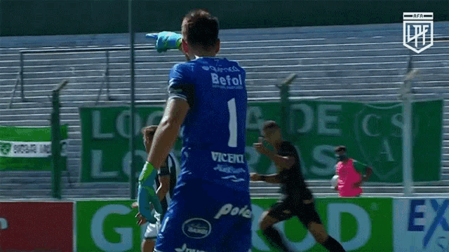 a soccer player wearing a blue jersey with the number 1 on it