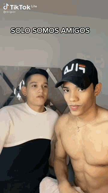 two shirtless men are standing next to each other with the caption solo somos amigos on the bottom