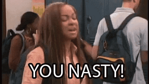 a girl is standing in a locker room with a backpack and a man standing behind her .