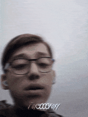 a blurry picture of a boy with glasses and the words fox00000foxy
