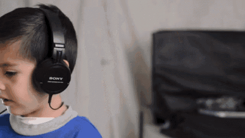 a boy wearing sony headphones looks at something