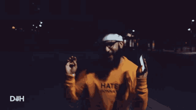 a man wearing a haters wanna hate shirt is dancing