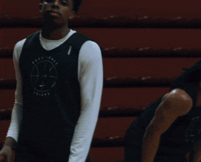 a man wearing a providence friars jersey waves