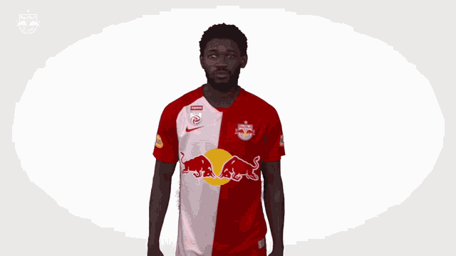 a man wearing a red and white red bull jersey