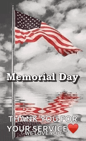a black and white photo of an american flag waving in the wind on memorial day .