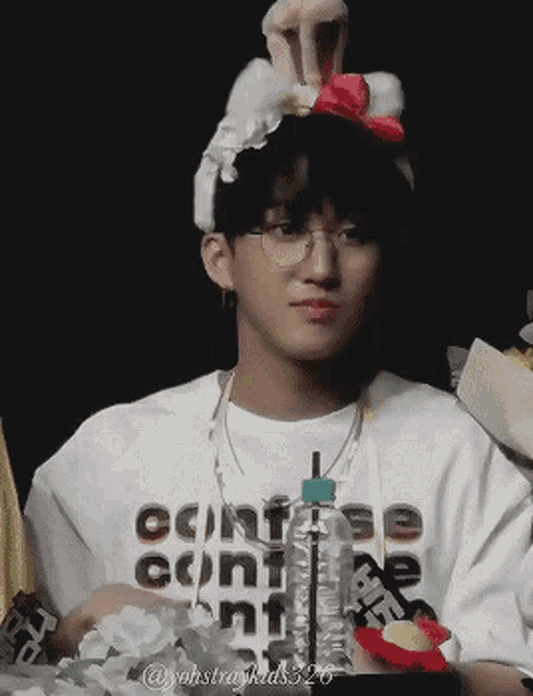 a young man wearing a white shirt that says converse