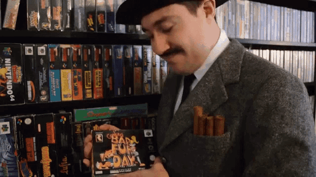 a man in a suit is holding a video game that says " bad fur day "