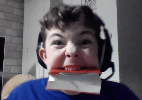 a boy making a funny face in front of a sign that says " no good "